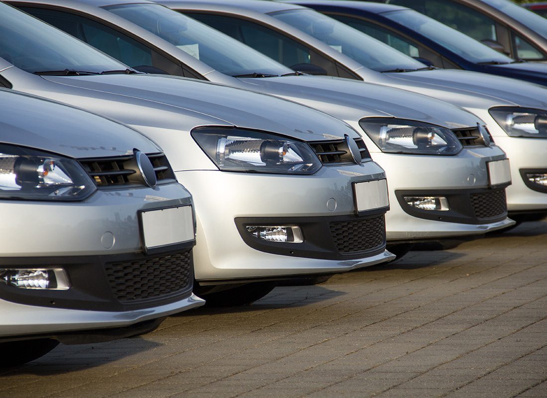 Business Insurance - Fleet of Silver Cars at a Lot on a Sunny Day