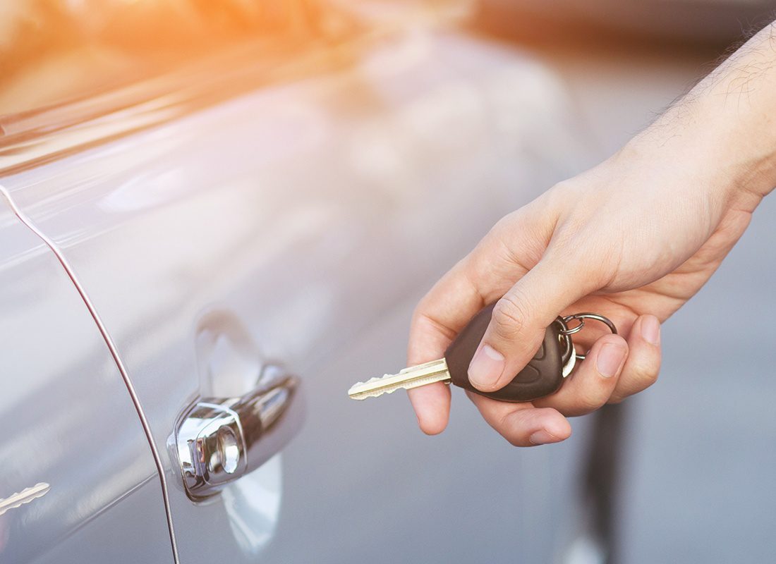 DMV Licensing Services - Close-up of a Person Using Car Keys to Open Car Door